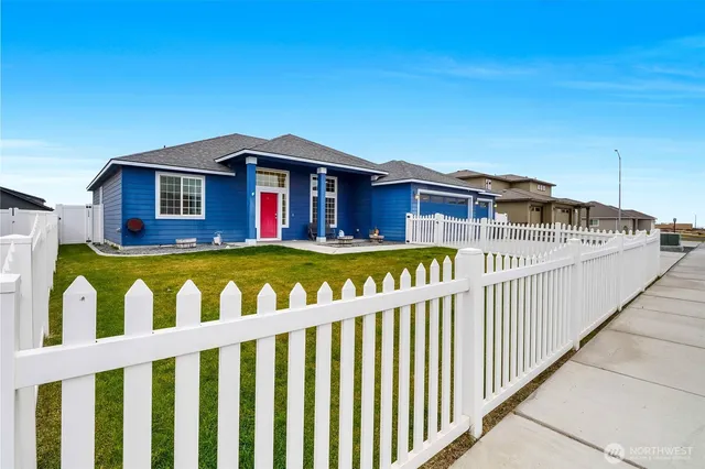 a view of a house with wooden fence