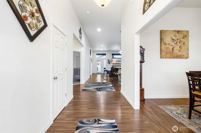 a view of a hallway with wooden floor and workspace