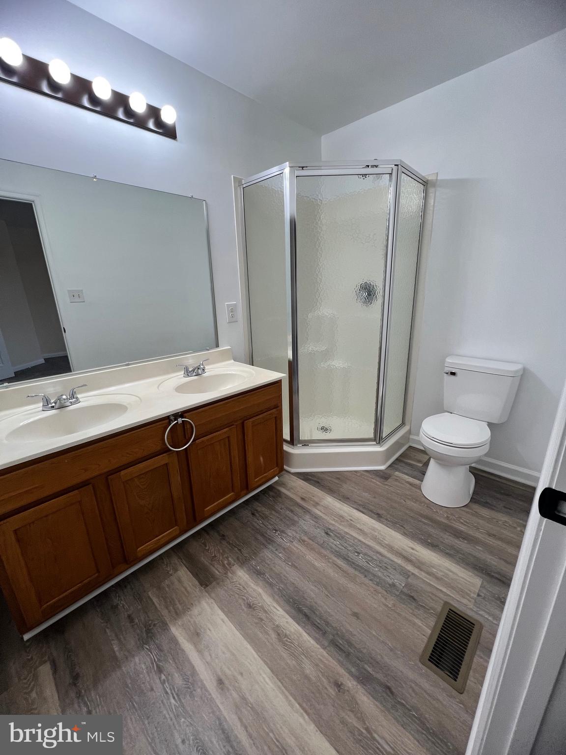15 Mistala Court Inwood, WV 25428 - Photo 26 of 35 a bathroom with a sink a toilet a mirror and shower