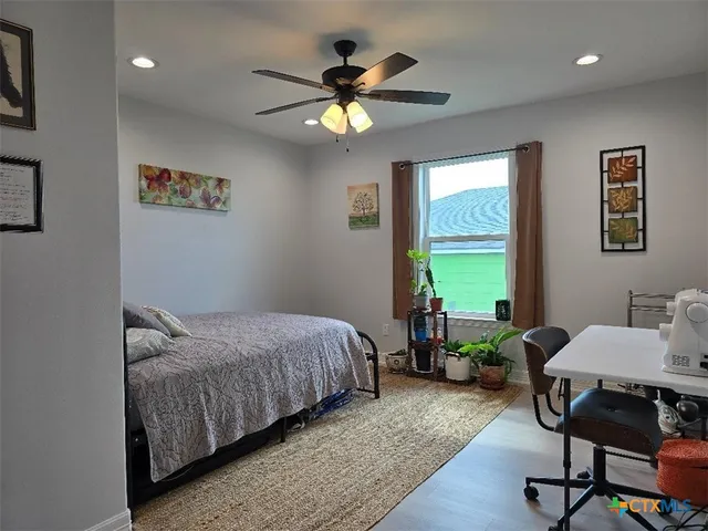 a bedroom with bed and a window