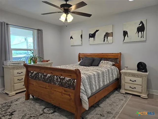 a bedroom with a bed and a window