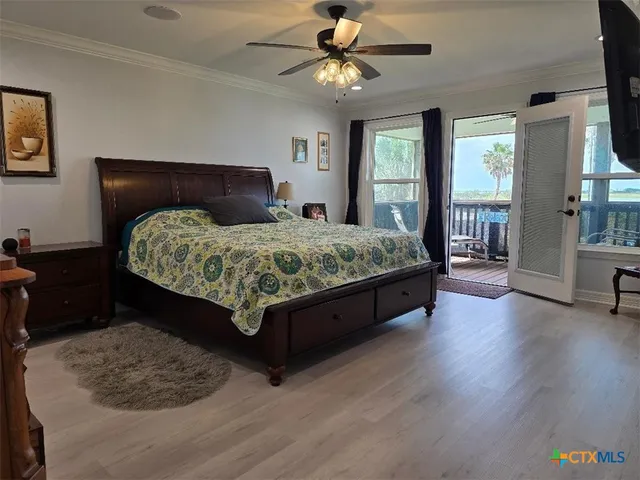 a bedroom with a bed a dresser and next to a window
