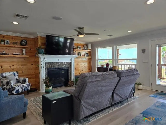 a living room with furniture a flat screen tv and a fireplace