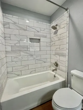 a white bath tub sitting next to a white toilet