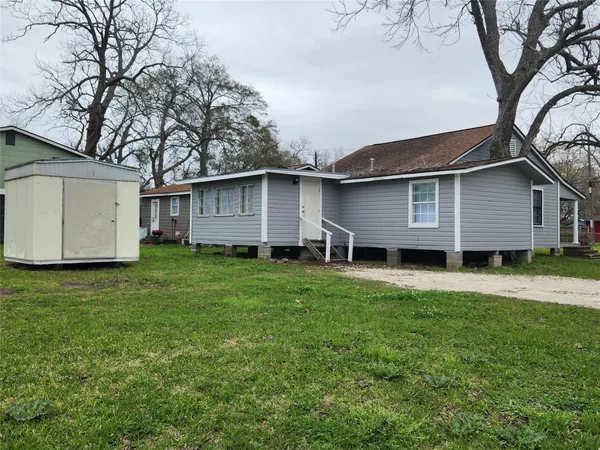 a front view of house with a garden