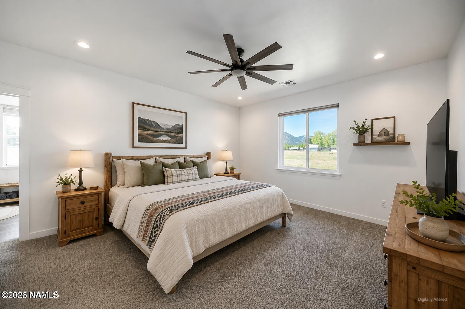 10272 Fw Mclure Road Flagstaff, AZ 86004 - Photo 6 of 38 a spacious bedroom with a bed and a flat screen tv