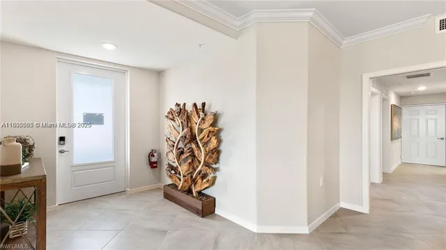 a living room with furniture a large window and kitchen view
