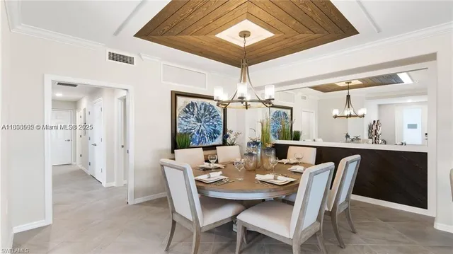 a dining room with furniture and chandelier