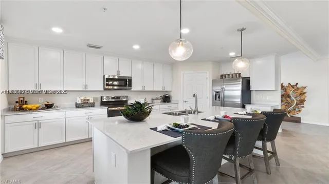 a kitchen that has a lot of cabinets in it and appliances
