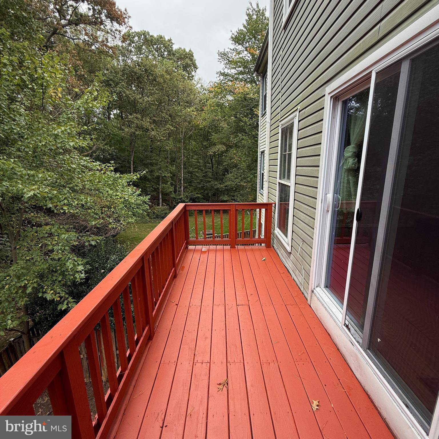 8222 Maple Ridge Avenue Springfield, VA 22153 - Photo 11 of 25 a balcony with wooden floor and trees