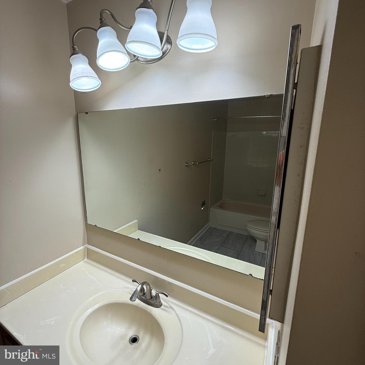 8222 Maple Ridge Avenue Springfield, VA 22153 - Photo 17 of 25 a bathroom with a sink and a mirror