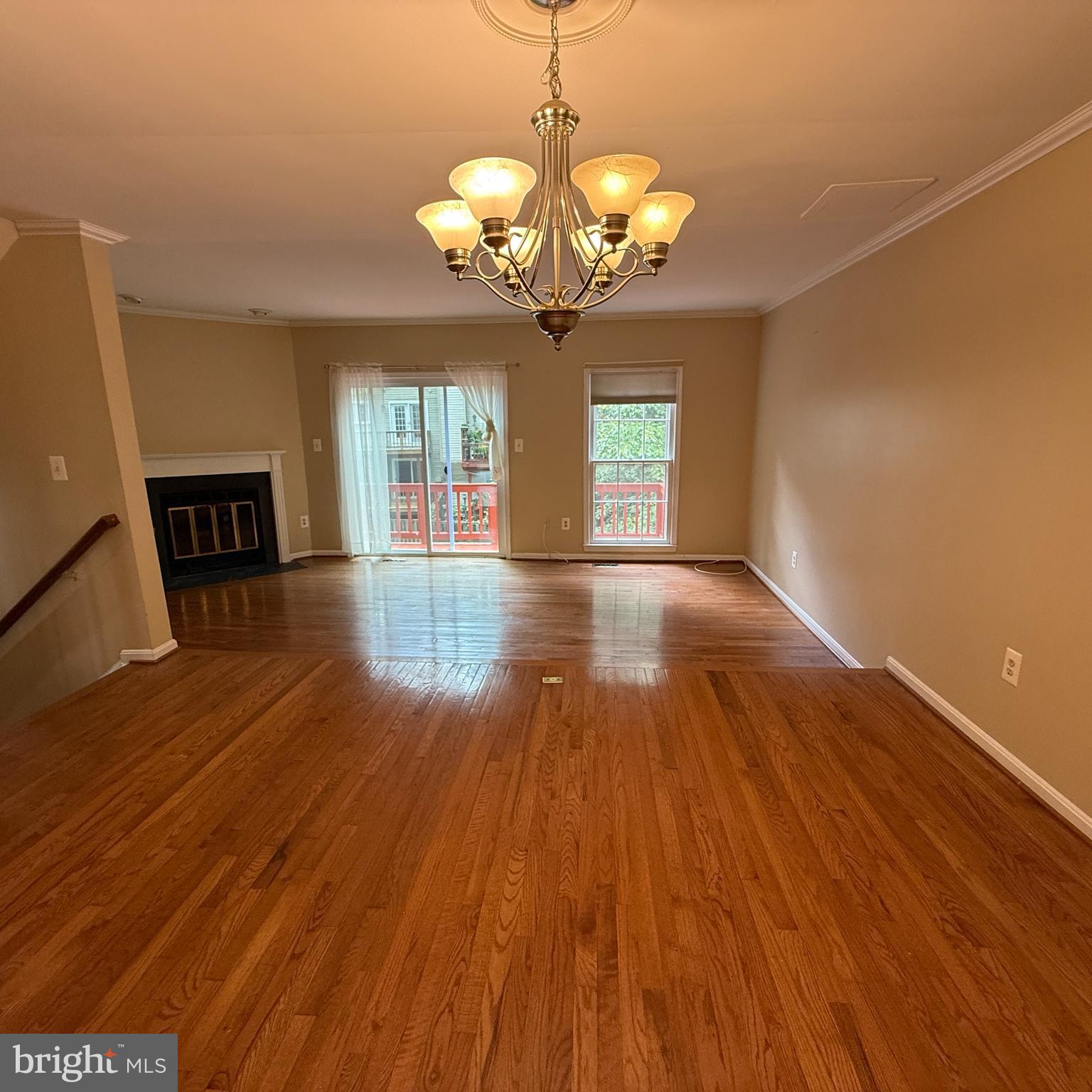 8222 Maple Ridge Avenue Springfield, VA 22153 - Photo 2 of 25 a view of a room with wooden floor and chandelier