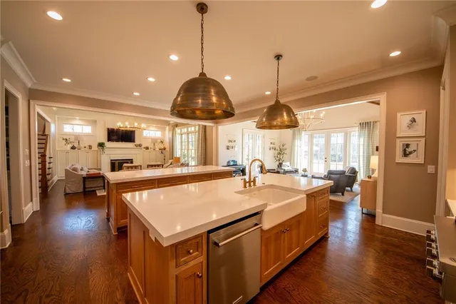a living room with furniture a wooden floor and chandelier
