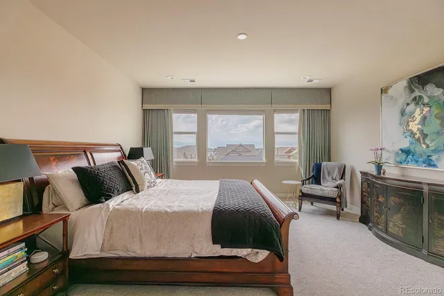 a bedroom with a large bed and a couch