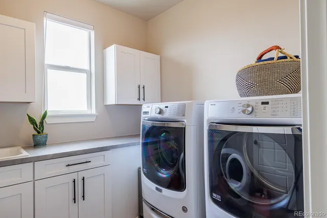 a living room with furniture and chandelier