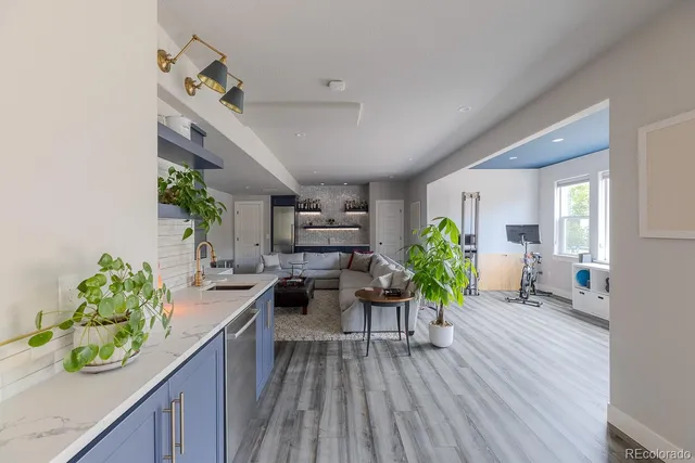 a living room with furniture and kitchen view