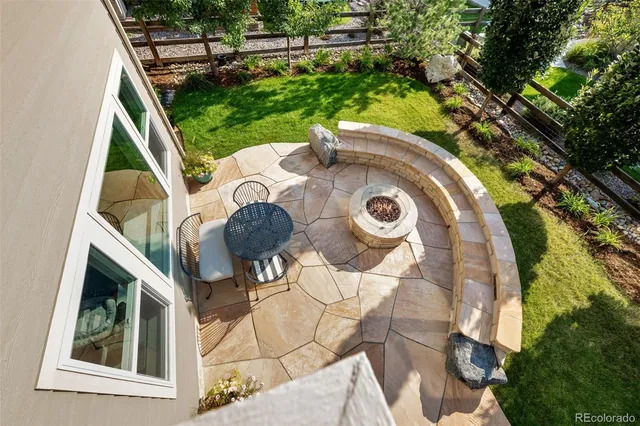 a view of a chair and table in the garden