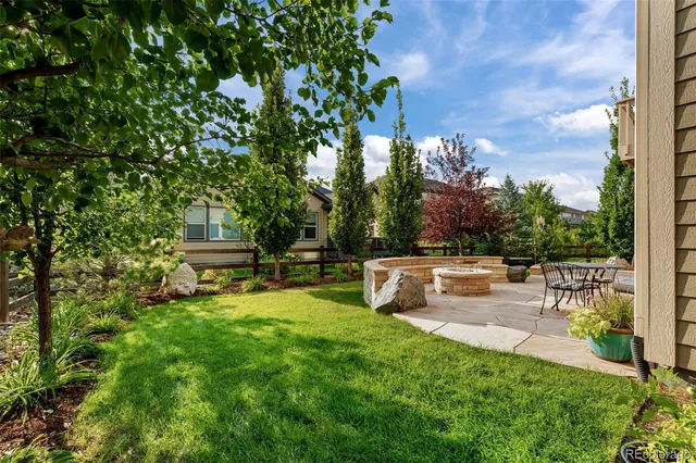 an aerial view of a house with a yard and potted plants