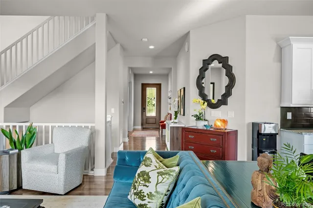 a living room with furniture a fireplace and potted plants