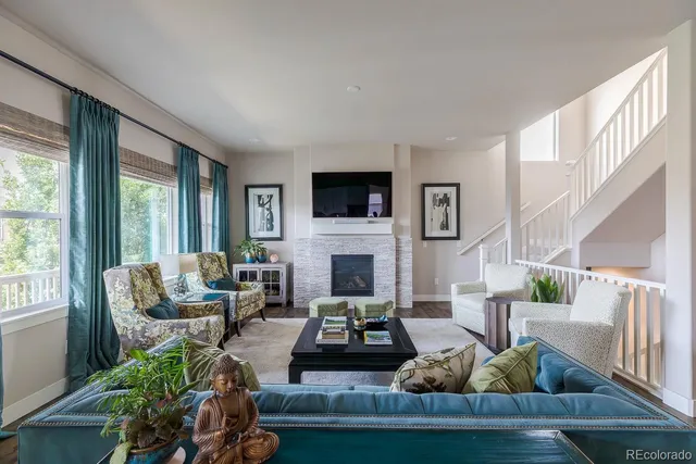a living room with furniture fireplace and flat screen tv