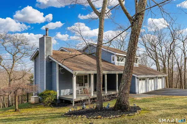 a front view of a house with swimming pool and glass windows