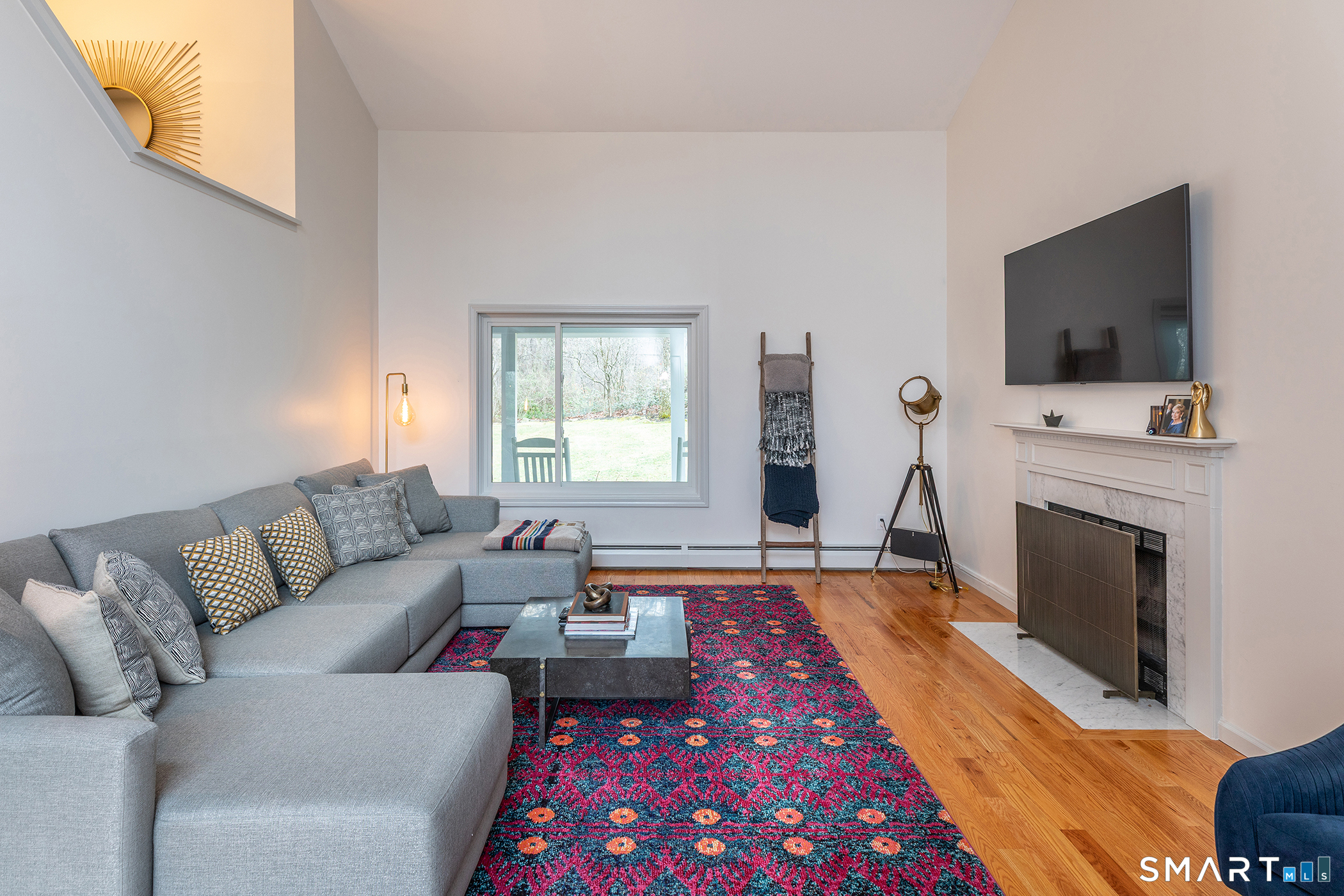 12 Silver Hill Road Sharon, CT 06069 - Photo 11 of 26 a living room with furniture a flat screen tv and a fireplace