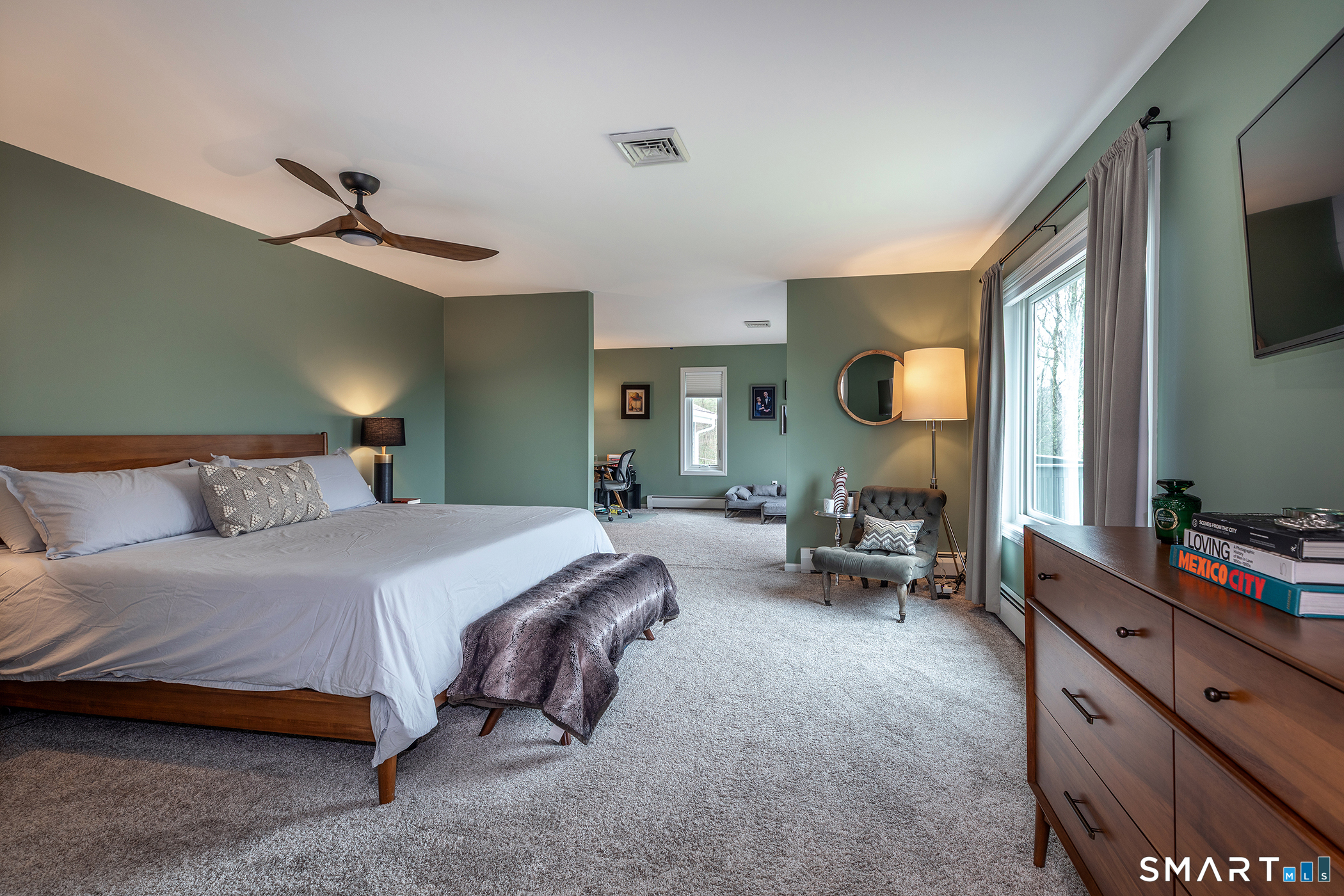 12 Silver Hill Road Sharon, CT 06069 - Photo 13 of 26 a spacious bedroom with a bed a couch and a flat tv screen on dresser