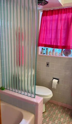 a bathroom with a toilet a sink and window