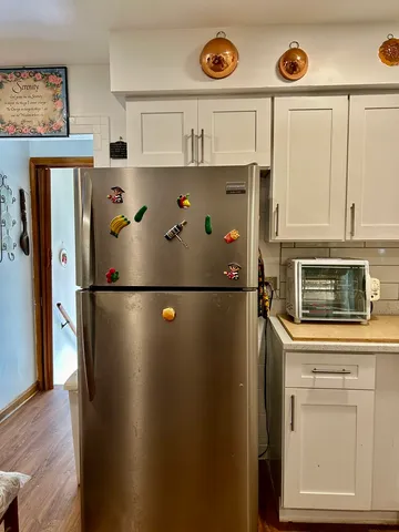 a front view of a house with entryway and wooden floor