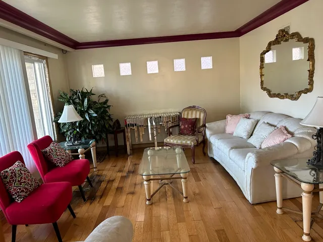a living room with furniture and a mirror