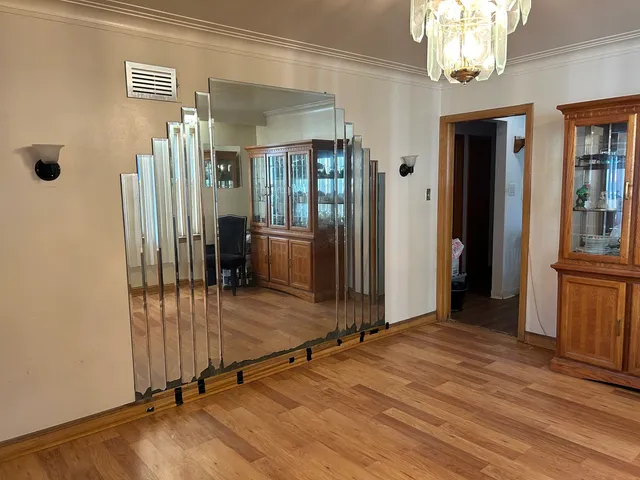 a view of a room with wooden floor and windows