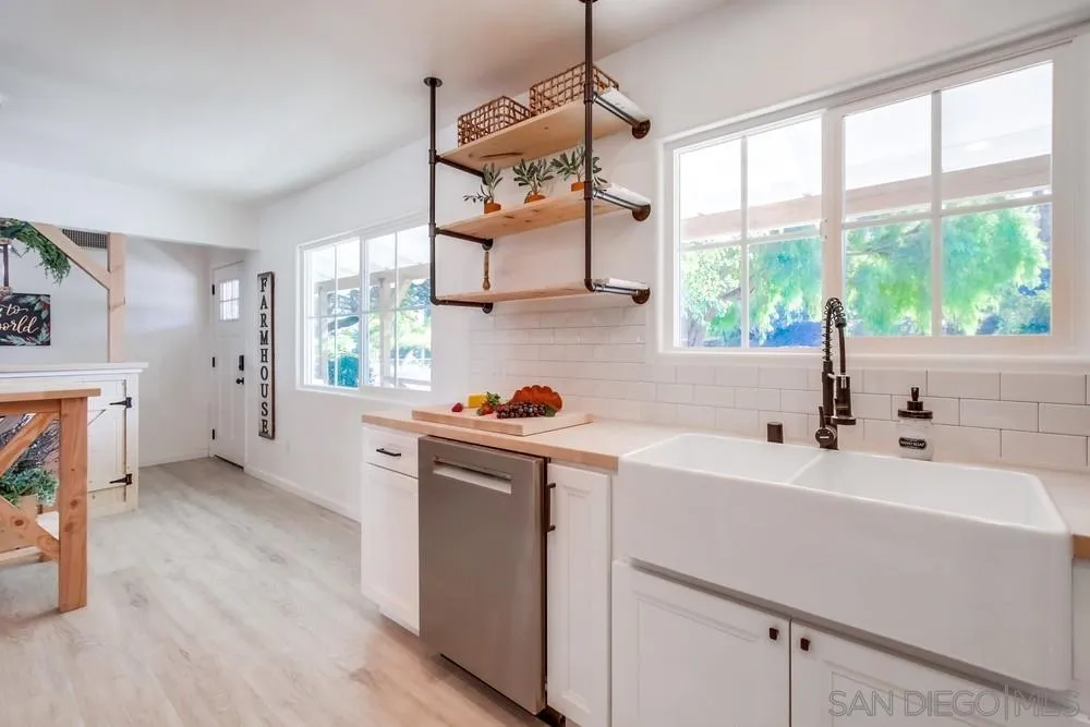 9130 Hillman Way Lakeside, CA 92040 - Photo 22 of 48 a kitchen with stainless steel appliances a sink a stove and a wooden floors