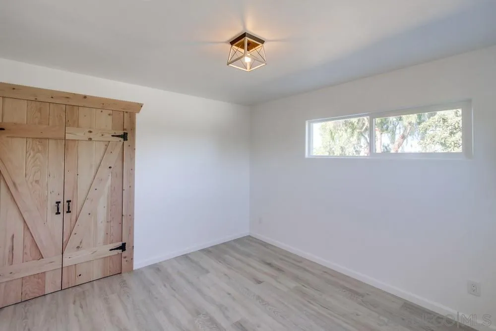 9130 Hillman Way Lakeside, CA 92040 - Photo 30 of 48 an empty room with wooden floor and windows