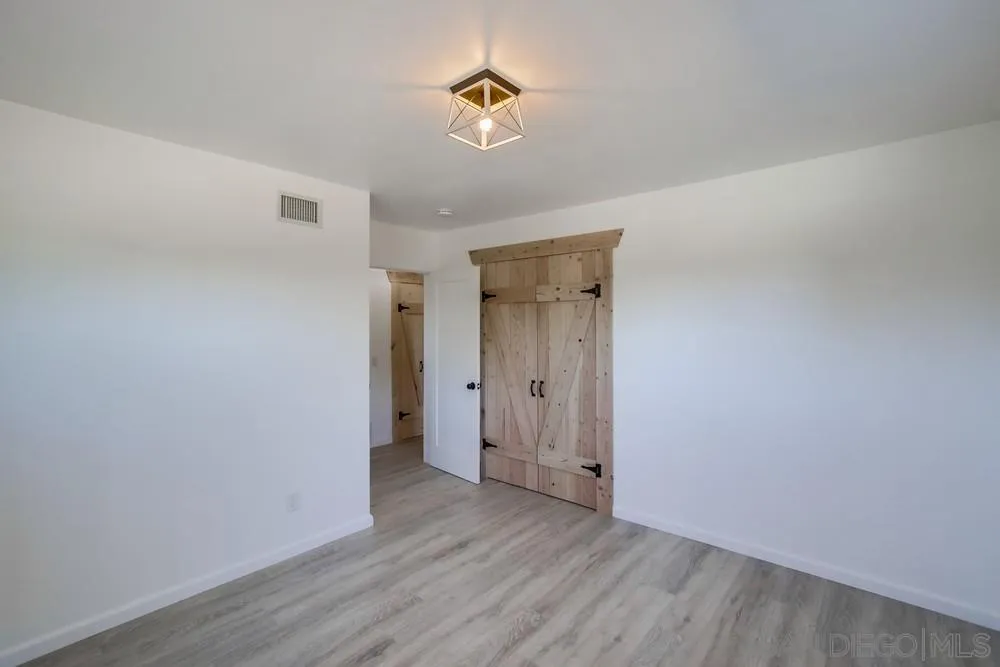 9130 Hillman Way Lakeside, CA 92040 - Photo 31 of 48 a view of an empty room with wooden floor