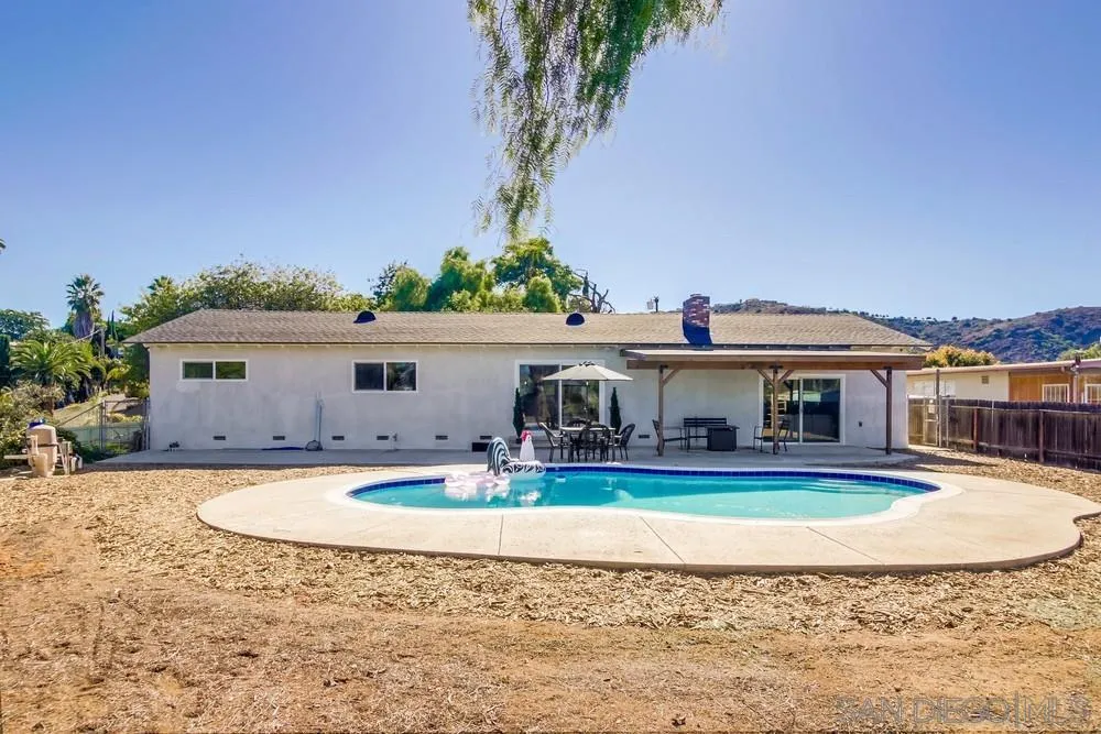 9130 Hillman Way Lakeside, CA 92040 - Photo 41 of 48 a view of a big house with a swimming pool and a yard