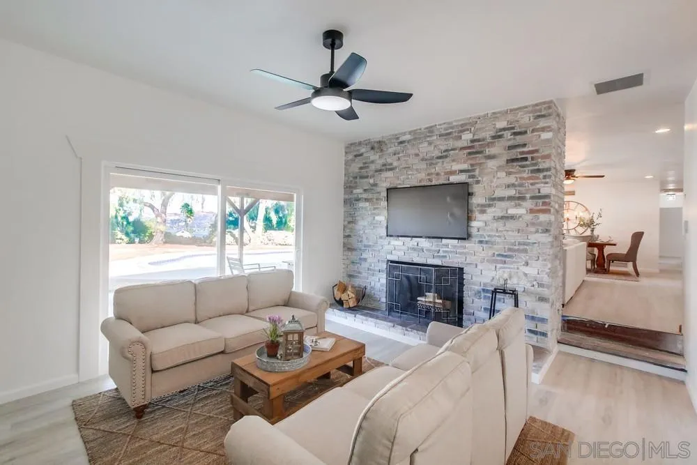 9130 Hillman Way Lakeside, CA 92040 - Photo 8 of 48 a living room with furniture a fireplace and a flat screen tv