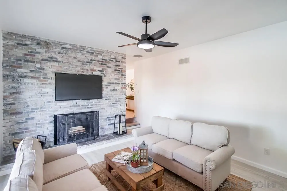 9130 Hillman Way Lakeside, CA 92040 - Photo 10 of 48 a living room with furniture a flat screen tv and a fireplace