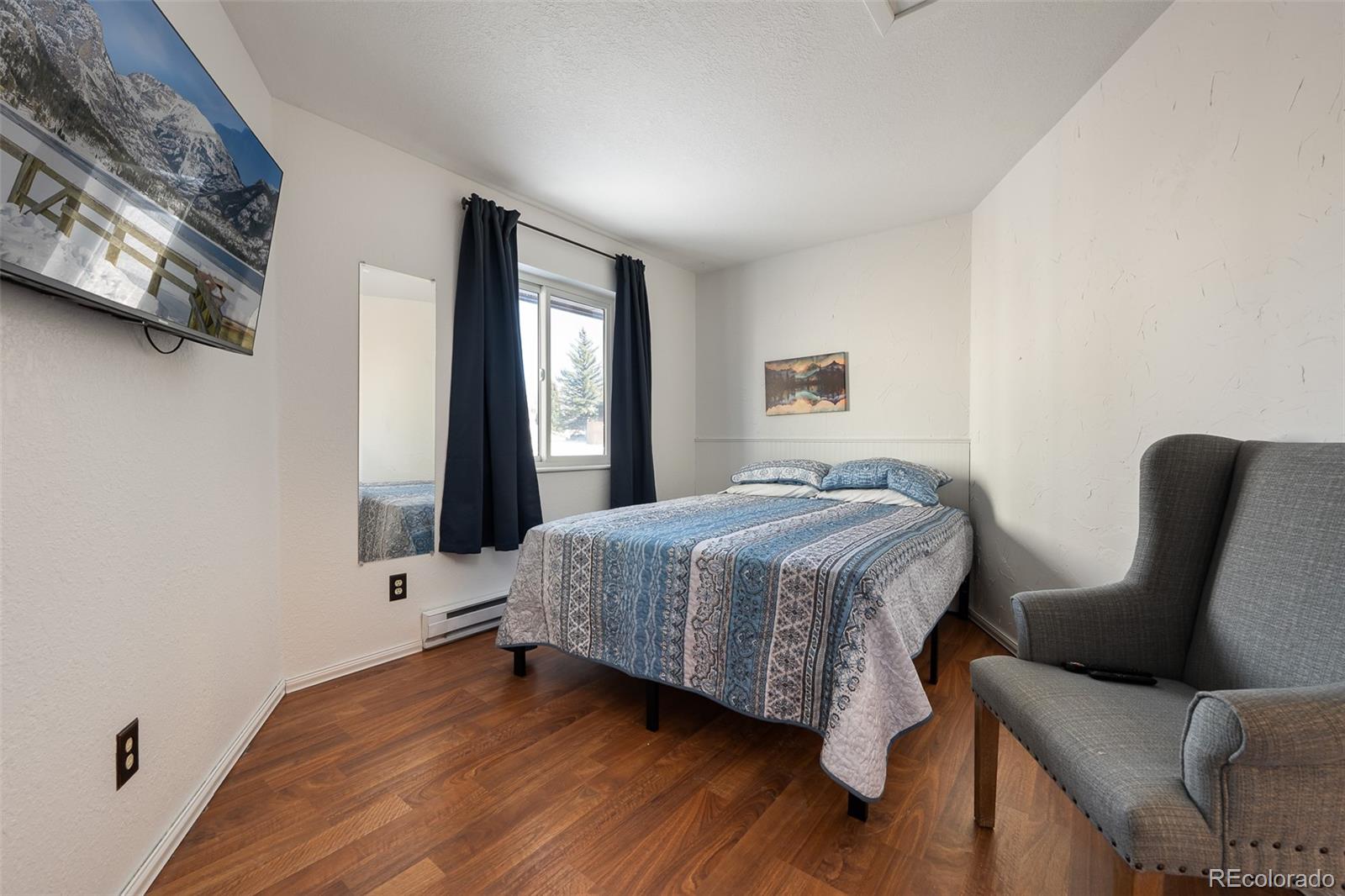 105 County Road, Unit 20 Grand Lake, CO 80447 - Photo 11 of 16 a bedroom with a bed and a chair