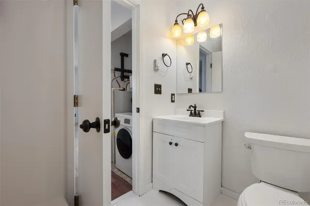 a bathroom with a sink mirror and toilet