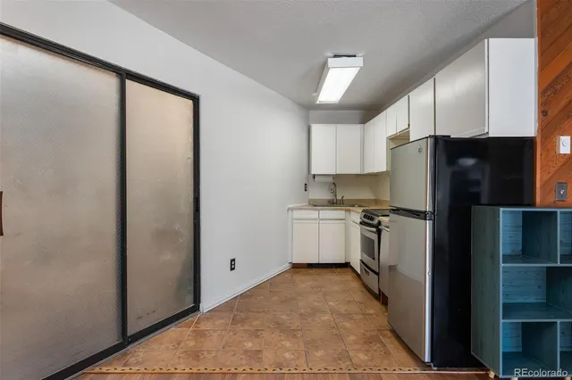 a kitchen with a refrigerator and a sink