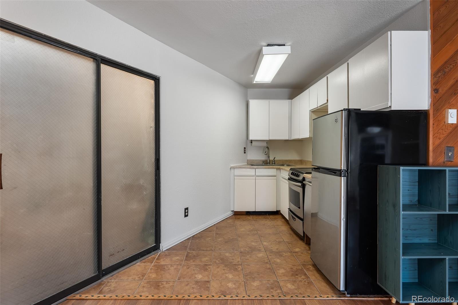 105 County Road, Unit 20 Grand Lake, CO 80447 - Photo 5 of 16 a kitchen with a refrigerator and a sink
