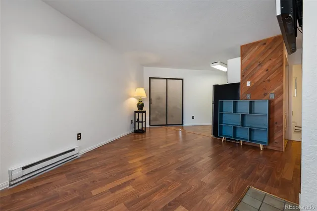 a view of a room with wooden floor and cabinet