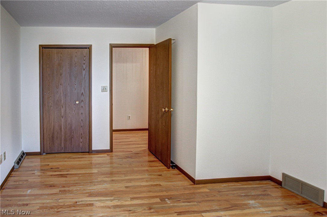 6013 Rousseau Drive Parma, OH 44129 - Photo 28 of 50 Unfurnished bedroom with light hardwood / wood-style flooring and a textured ceiling