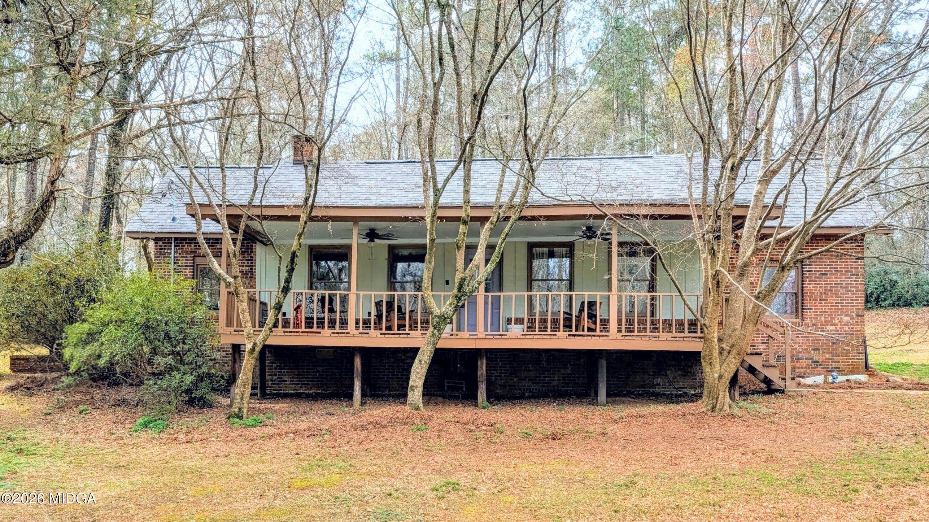 a view of a house with a yard and sitting area