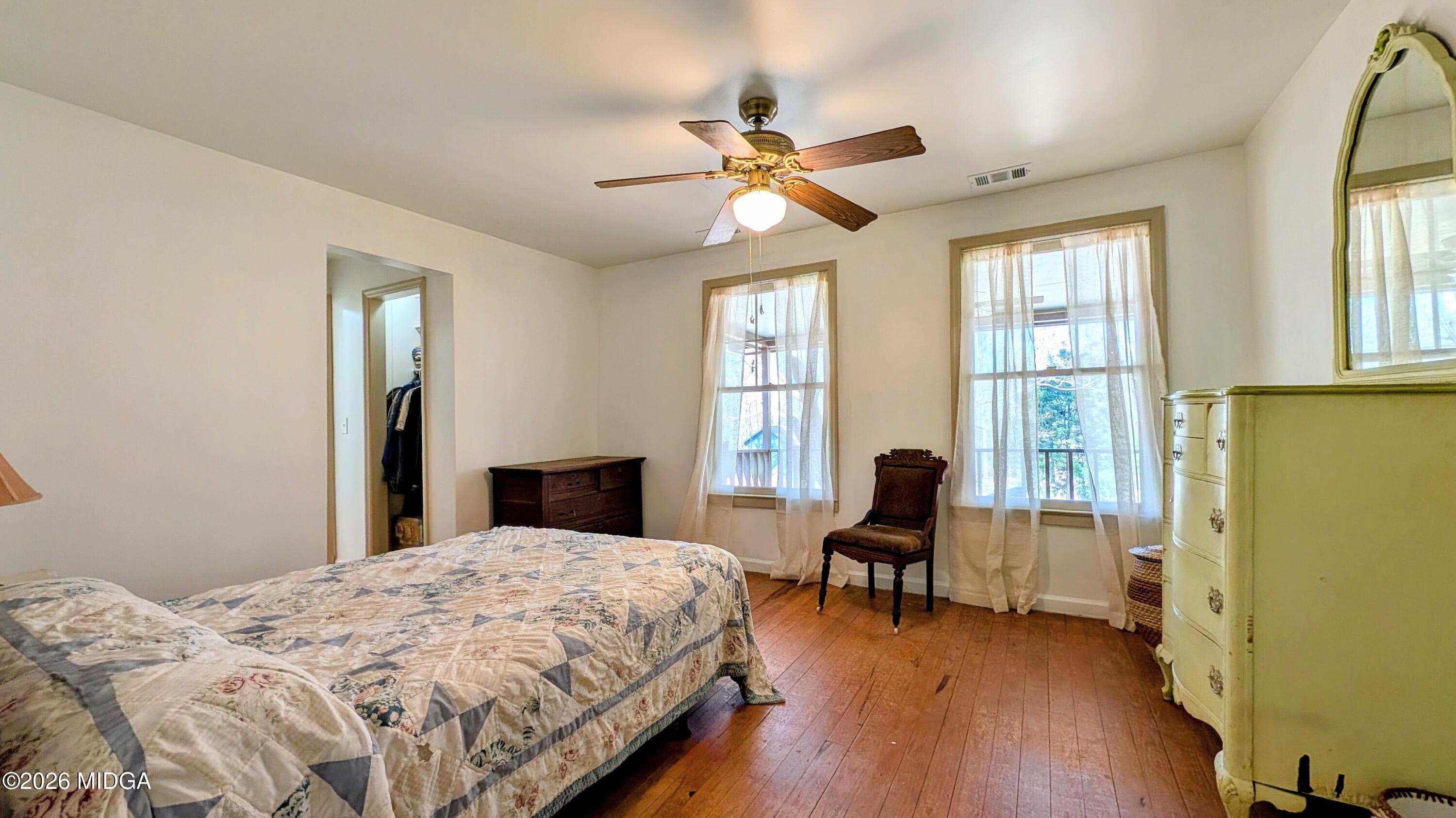 1068 Lamar Road Macon, GA 31210 - Photo 12 of 39 a bedroom with a bed and wooden floor