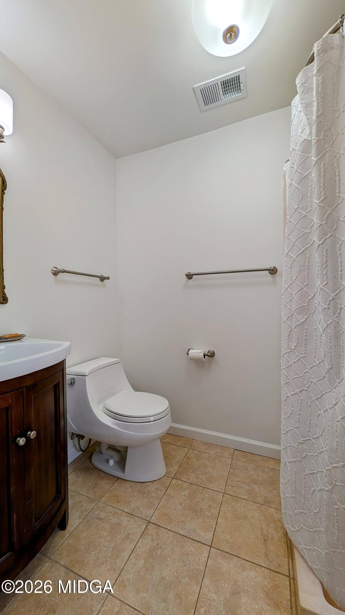 1068 Lamar Road Macon, GA 31210 - Photo 14 of 39 a bathroom with a toilet and a shower