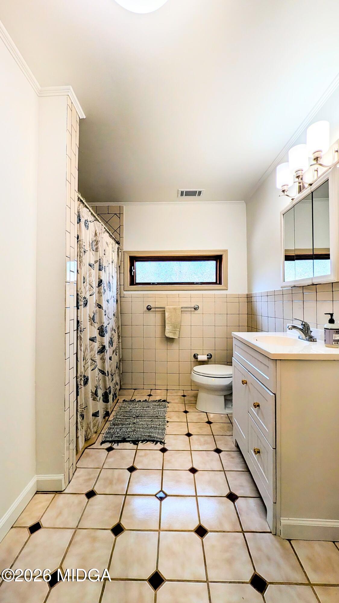 1068 Lamar Road Macon, GA 31210 - Photo 15 of 39 a spacious bathroom with a double vanity sink toilet and shower