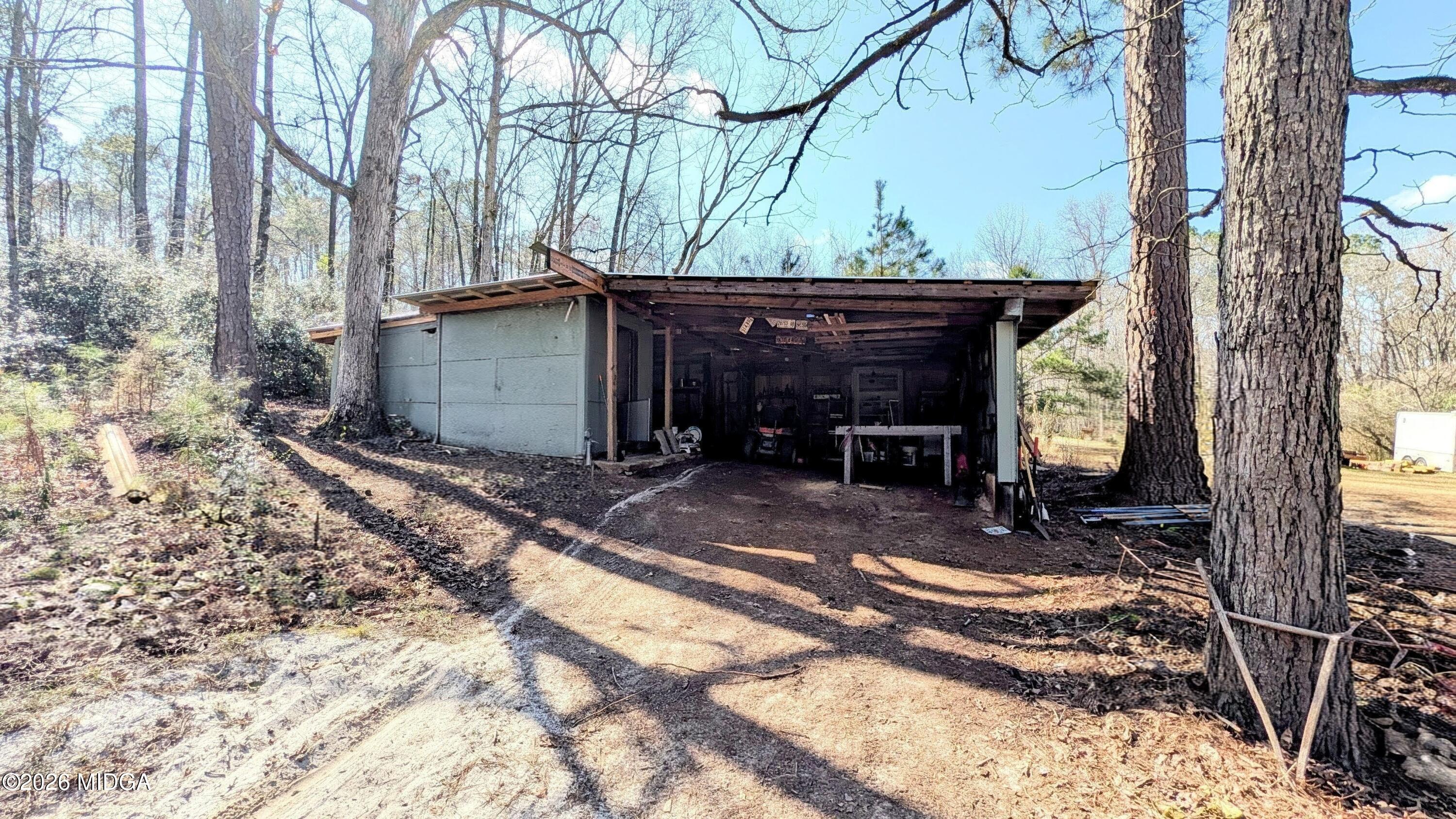 1068 Lamar Road Macon, GA 31210 - Photo 27 of 39 a view of a house with a yard chairs and wooden fence