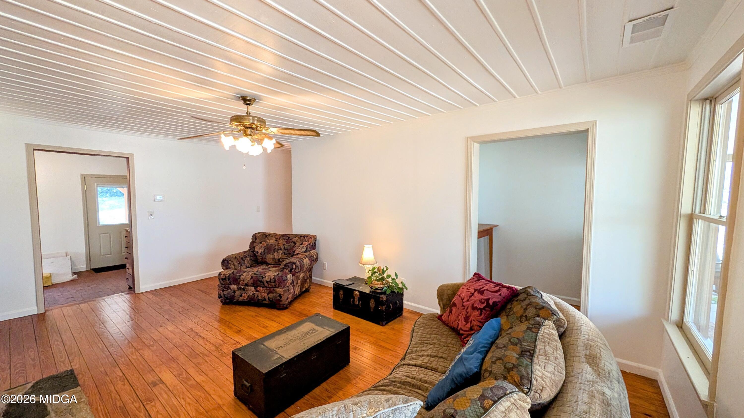 1068 Lamar Road Macon, GA 31210 - Photo 8 of 39 a living room with furniture and a chandelier