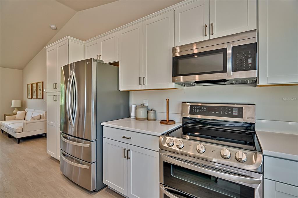 256 Portland Street Hawthorne, FL 32640 - Photo 12 of 35 a kitchen with appliances a sink and cabinets
